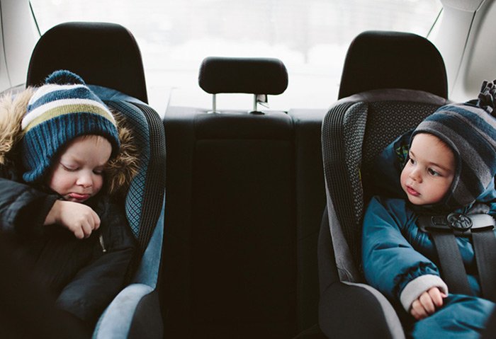 A child in a car seat in a jacket