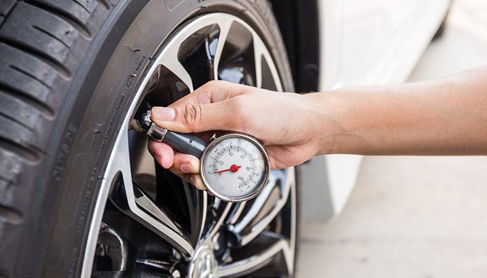 What is the danger of driving on a flat tire?